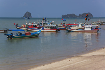 Bright colorful fishing boats anchored near wild beach, Langkawi