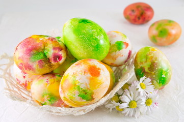 Painted Easter eggs and daisy flowers