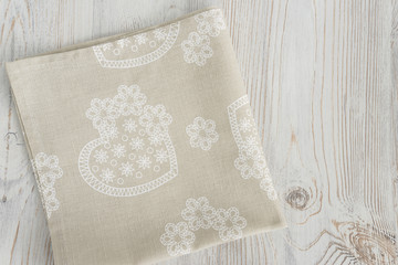 folded linen napkin on light wooden background