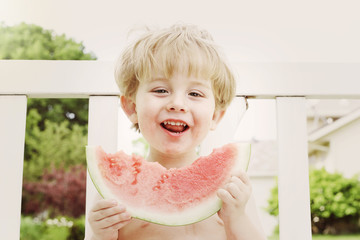 Young boy eating watermelon