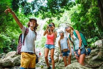 Fototapeta premium group of tourists exploring jungle in thailand