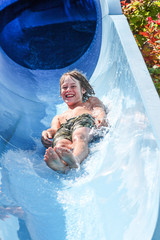 Boy on a tube going down a water slide
