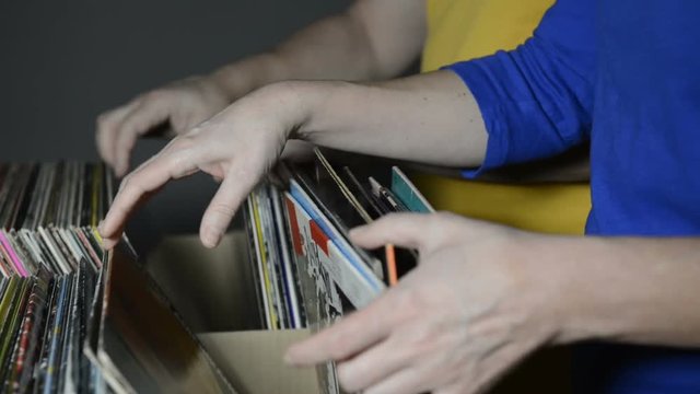 couple searching records in a music store
