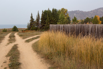 Fototapeta premium Country road near the shore of the lake. Lake Baikal. Village Davsha. Russia.