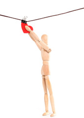 Wooden figure of the person and heart on a rope with a clothespe
