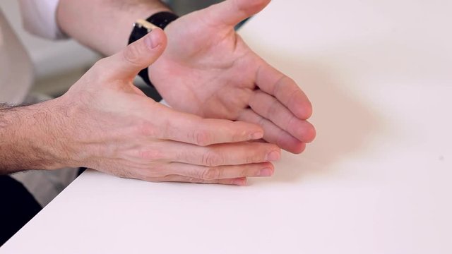 Sign Language in Negotiations/A man makes gestures while having a conversation