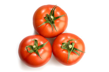 three realistic looking tomatoes lying in a triangle isolated in