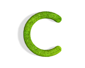 Grass letter C in uppercase format from top angle with shadow on ground.