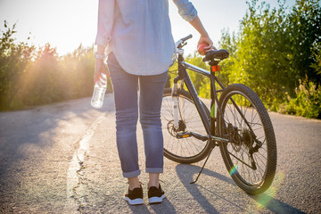 Naklejka premium in the summer on a sunny day walk on the bike, the girl goes in for sports
