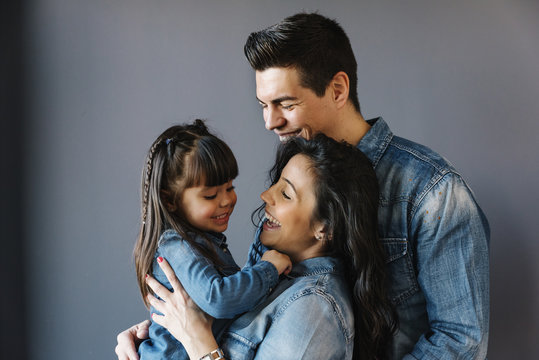 Happy young family with their daughter.