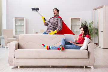 Superhero husband helping his wife at home