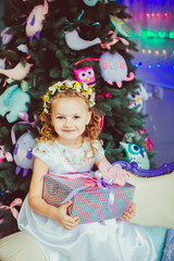 Charming smile of the beautiful girl with the present