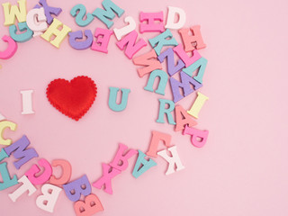 Vanlentine's day concept. Wooden color letters word love and red heart  on color background with copy space.watering can  love concept.