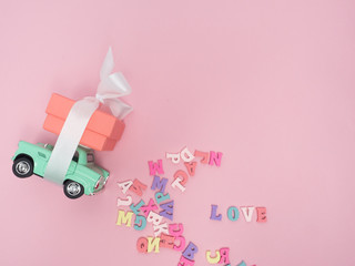 Vanlentine's day concept. Wooden color letters word love and red heart  on color background with copy space.watering can  love concept.