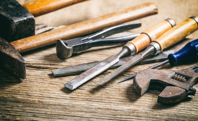 Old hand tools on wooden background
