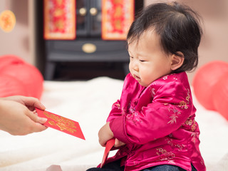 happy baby girl get red envelope with "FU" means lucky for her f
