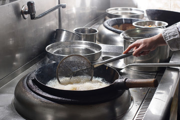 Close up of working chef preparing chinese food