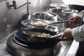Close up of working chef preparing chinese food