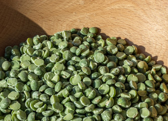 Green peas on the background of wood texture.