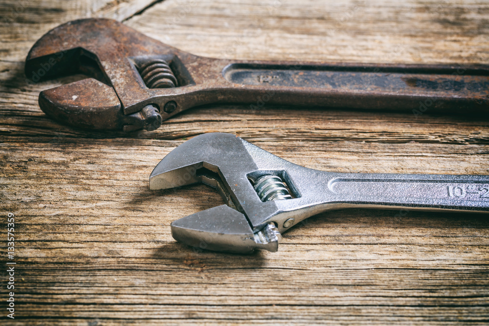 Wall mural two wrenches on wooden background