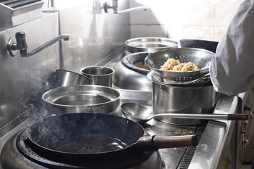 Close up of working chef preparing chinese food