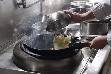 Close up of working chef preparing chinese food