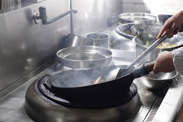 Close up of working chef preparing chinese food