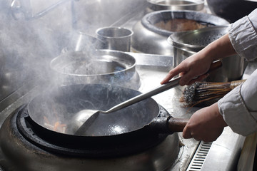 Close up of working chef preparing chinese food