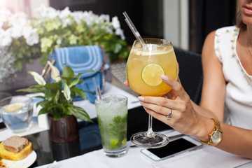 Woman enjoying cocktail at restaurant.