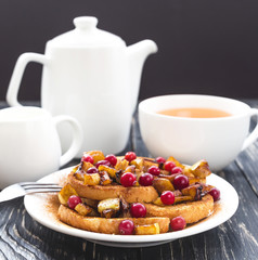 Hot french toasts with caramelized apples, and tea