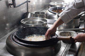 Close up of working chef preparing chinese food