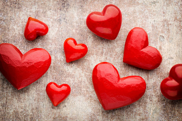 Red hearts on the wooden background.