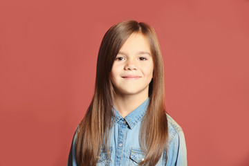 Fototapeta premium Portrait of cute little girl on color background