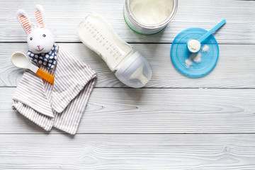 preparation of mixture baby feeding on wooden background top view