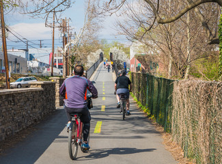 Obraz premium People ride on urban bike path in city