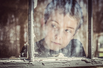 Boy looking out a window