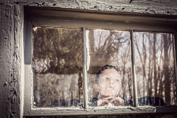 Boy looking out a window