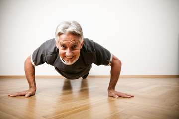 Fototapeta na wymiar Man In His 50s Doing Pushups