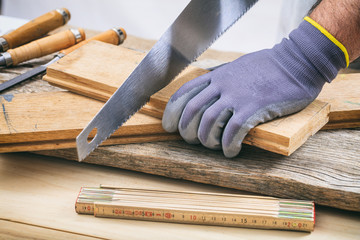 Man working with a hand saw