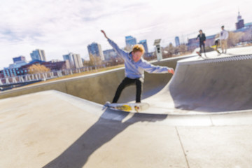 boy skating on skateboard in skate park. skateboarder riding skateboard. the concept of freestyle extreme sport. blurred background due to the concept. empty space for your text