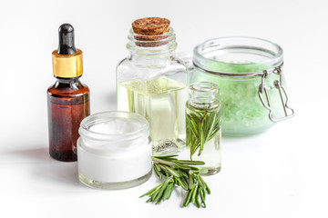 organic cosmetics with extracts of herbs rosemary on white background