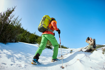 hiker with backpack on the trail in the Carpathians mountains at winter