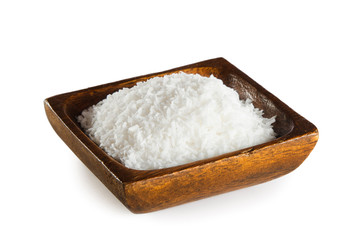 Shredded coconut in wooden bowl