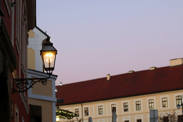 Fototapeta na wymiar Retro lantern on Kaptol, Zagreb, Croatia. Lit at dusk. Selective focus. 