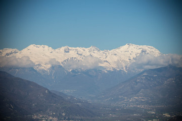 Snowy Alps and clouds in Val di Susa. Vignette effect. Piedmont. Italy