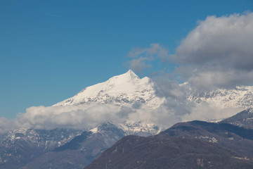 Snowy Alps and clouds in Val di Susa. Piedmont. Italy