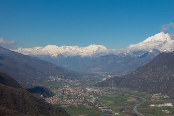 Obraz premium Val di Susa with its villages and snowy Alps on background. Piedmont. Italy