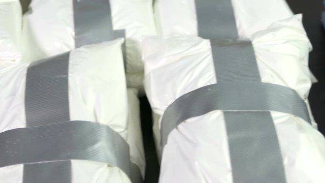 Seized drugs, money, gun, and burner phones on table