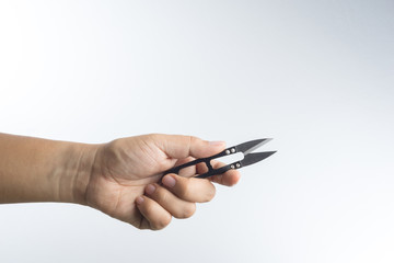 Hand holding thread scissors
