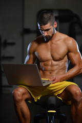 Fototapeta na wymiar Portrait Of A Physically Fit Man Using Laptop